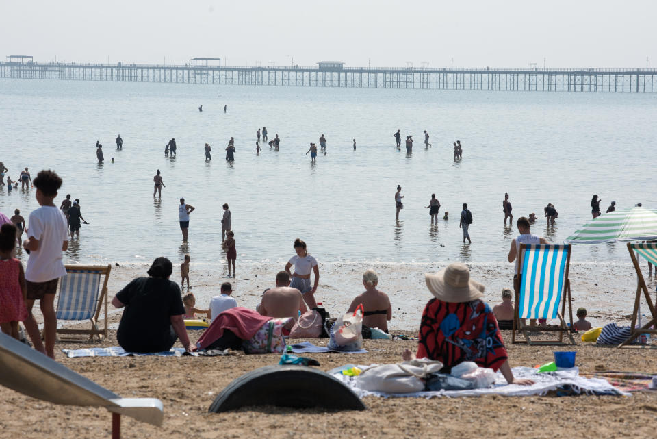 SOUTHEND-ON-SEA, ENGLAND AUGUST 11: People walk out from the beach at low tide to cool down in the water during the recent hot weather on August 11, 2020 in Southend on Sea, England. Parts of the UK remain in the grip of a Summer heatwave that has seen temperatures rise above 30 degrees in much of the country. (Photo by John Keeble/Getty Images)