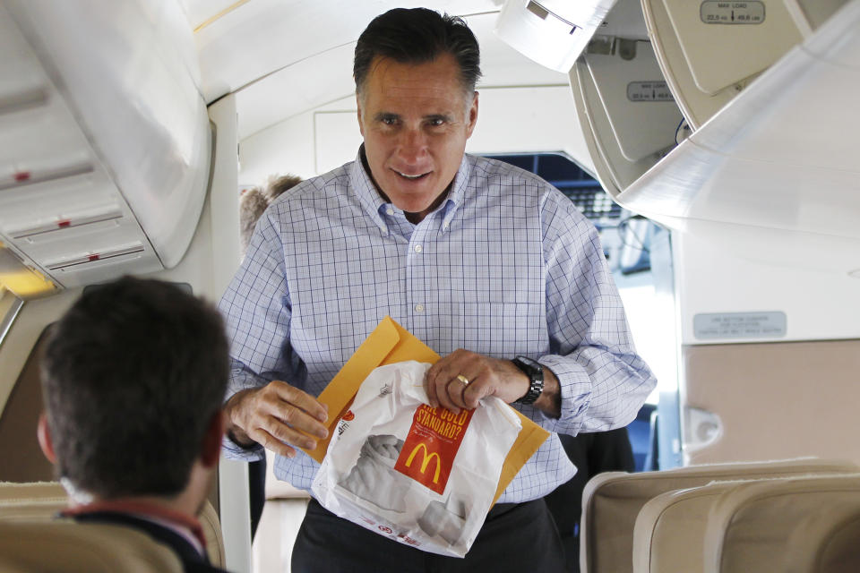 Republican presidential candidate and former Massachusetts Gov. Mitt Romney carries a McDonald's bag as he boards his charter plane in Centennial, Colo., Thursday, Aug. 2, 2012, en route to Aspen, Colo. (AP Photo/Charles Dharapak)