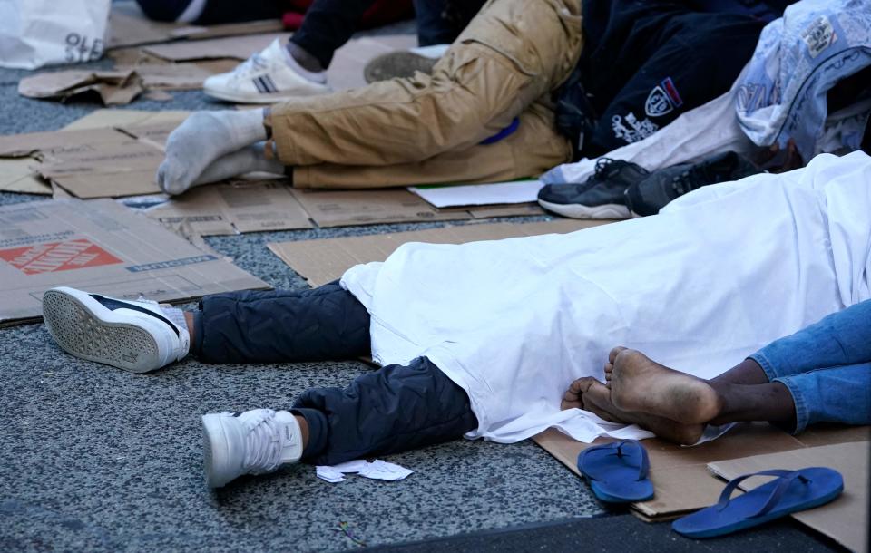 Migrants sleep outside the Roosevelt Hotel as they wait for placement at the hotel in New York on August 1, 2023. Many newly arrived migrants have been waiting outside the Roosevelt Hotel, which has been turned into a migrant reception center, to try to secure temporary housing. (Photo by TIMOTHY A. CLARY / AFP) (Photo by TIMOTHY A. CLARY/AFP via Getty Images) ORIG FILE ID: AFP_33QG8TJ.jpg