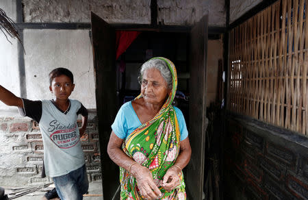 Sahar Bhan Bewa (C) whose name is excluded from the draft list of the National Register of Citizens (NRC), stands outside her house in Dhubri district, in the northeastern state of Assam, India August 3, 2018. REUTERS/Adnan Abidi