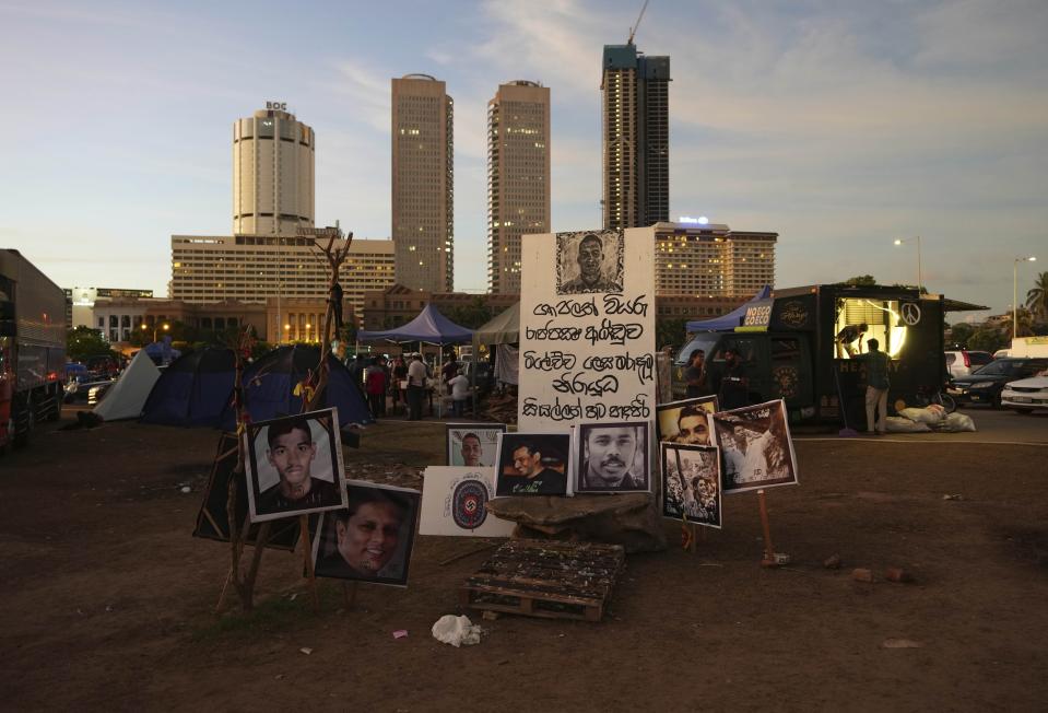 Portraits of people who were allegedly killed by government forces are displayed at an ongoing protest site outside the president's office in Colombo, Sri Lanka, Sunday, April 24, 2022. Thousands of Sri Lankans have protested outside President Gotabaya Rajapaksa’s office in recent weeks, demanding that he and his brother, Mahinda, who is prime minister, quit for leading the island into its worst economic crisis since independence from Britain in 1948. (AP Photo/Eranga Jayawardena)