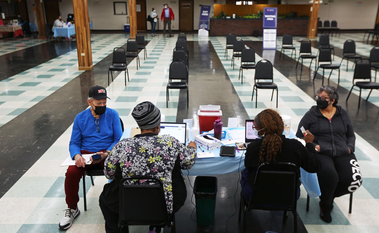 Patients wait to receive their second boosters at a COVID-19 testing and vaccination site at the Harvard Street Neighborhood Health Center in Boston on April 5, 2022.