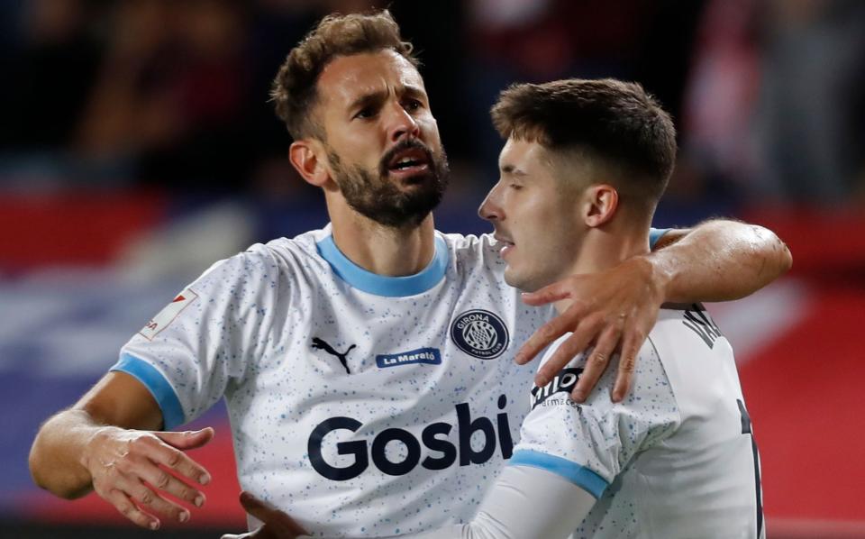 Girona's Valery Fernandez and Cristhian Stuani   embrace