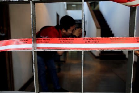 A local photographer takes a photo of journalist Carlos Fernando Chamorro's office, which was raided Thursday night by the national police in Managua, Nicaragua December 14, 2018. REUTERS/Oswaldo Rivas