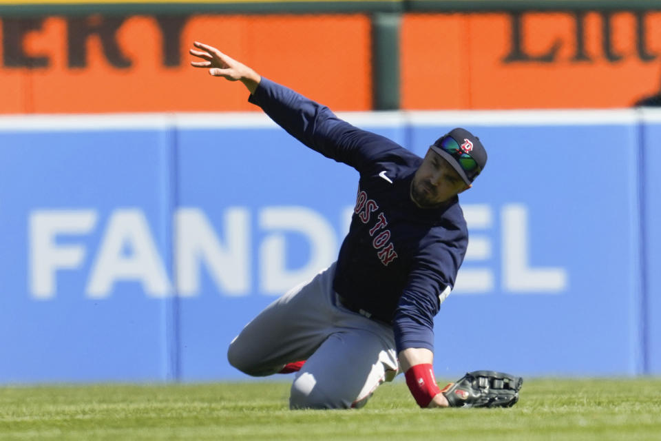 Boston Red Sox center fielder Adam Duvall attempts to catch a Detroit Tigers' Spencer Torkelson fly ball in the ninth inning of a baseball game in Detroit, Sunday, April 9, 2023. Duvall was injured on the play and left the game. (AP Photo/Paul Sancya)