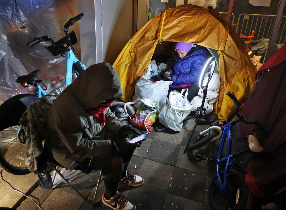 Yessica Karolina Badell Palmar, right, a migrant from Venezuela, in her tent outside the Chicago police 1st District station on Oct. 30, 2023.  (Terrence Antonio James  / Chicago Tribune via Getty Images file)