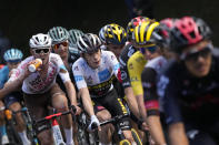 Denmark's Jonas Vingegaard, wearing the best young rider's white jersey, follows Slovenia's Tadej Pogacar, wearing the overall leader's yellow jersey, right, while Australia's Ben O'Connor, left, drinks, during the eighteenth stage of the Tour de France cycling race over 129.7 kilometers (80.6 miles) with start in Pau and finish in Luz Ardiden, France,Thursday, July 15, 2021. (AP Photo/Christophe Ena)