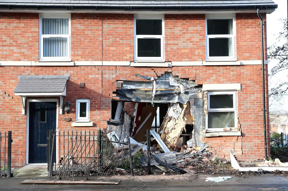 A gritter crashed into a house in Chester Road, Helsby, Cheshire, early on Monday. The road was closed entirely while the site was cleared. (PA).