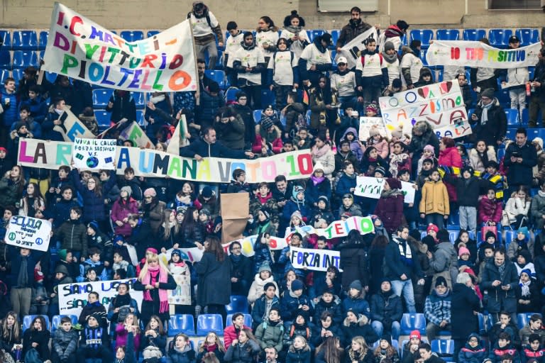 Young fans from local primary schools hold banners against racism during Inter Milan's match against Sassuolo at the San Siro stadium