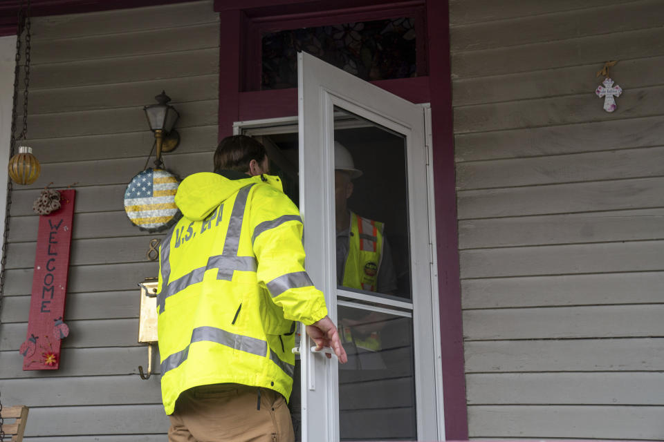 EPA officials knock on doors and talk to residents in East Palestine, Ohio, Thursday, Feb. 16, 2023. Residents of the Ohio village upended by a freight train derailment are demanding to know if they're safe from the toxic chemicals that spilled or were burned off to avoid an even bigger disaster. (Lucy Schaly/Pittsburgh Post-Gazette via AP)