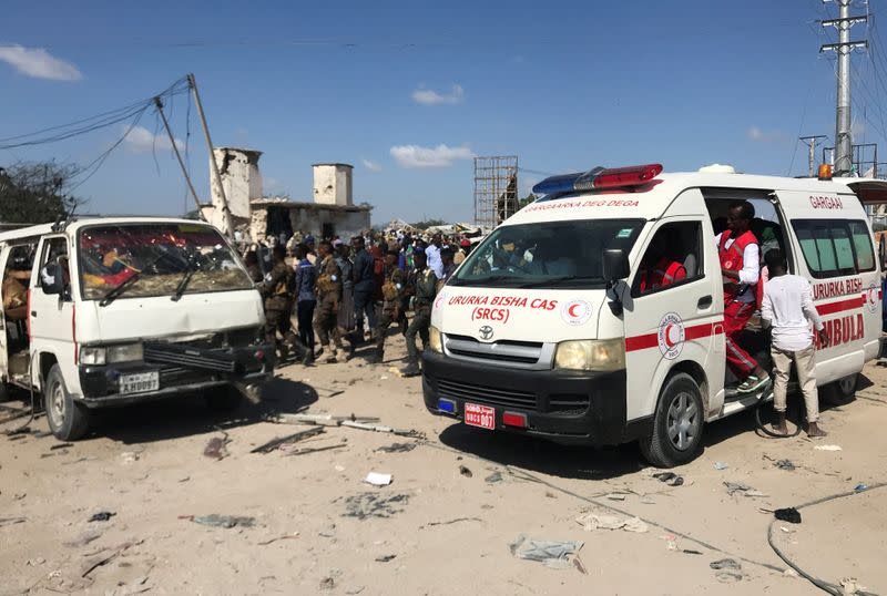 An ambulance leaves from the scene of a car bomb explosion at a checkpoint in Mogadishu