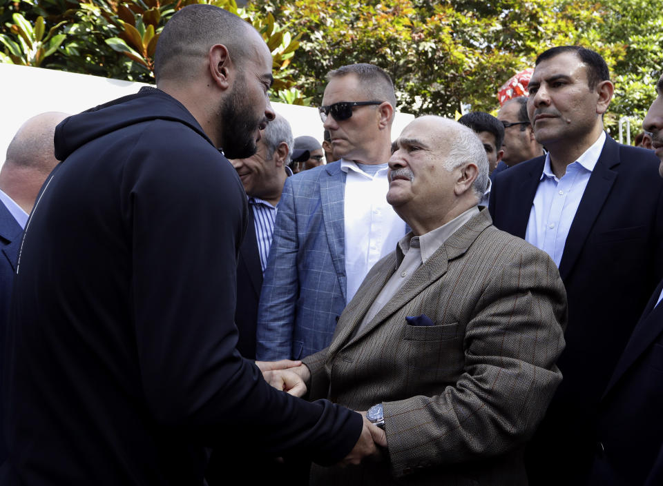 His Royal Highness Prince El Hassan bin Talal Hashemite, second right, of the Kingdom of Jordan greets a worshipper outside the Al Noor mosque in Christchurch, New Zealand, Saturday, March 23, 2019. The mosque reopened today following the March 15 mass shooting. (AP Photo/Mark Baker)