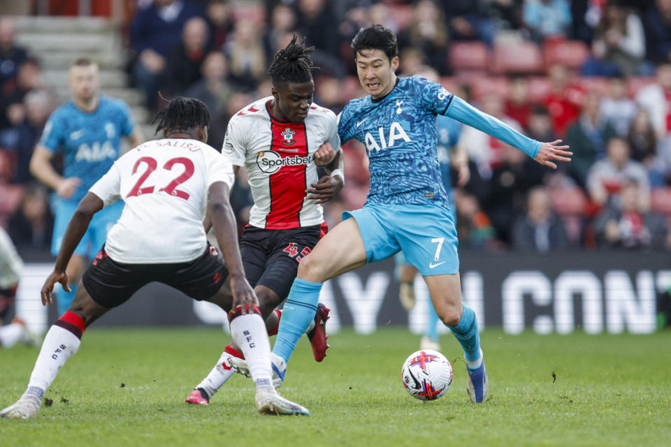 Tottenham's Son Heung-min, right, and Southampton's Romeo Lavia, center, compete for the ball during the English Premier League soccer match between Southampton and Tottenham at St Mary's Stadium in Southampton, England, Saturday, March 18, 2023. (AP Photo/David Cliff)