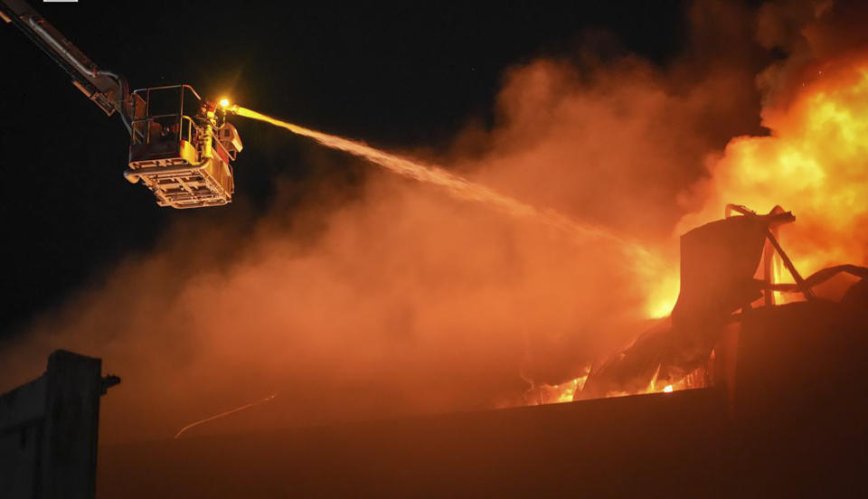 In this photo provided by the Ukrainian Emergency Service, emergency services personnel work to extinguish a fire following a Russian attack in Odesa, Ukraine, Wednesday, May 1, 2024. (Ukrainian Emergency Service via AP)