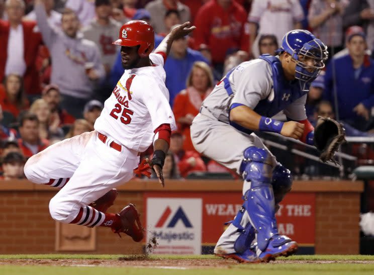 St. Louis Cardinals’ Dexter Fowler, left, scores past Chicago Cubs catcher Willson Contreras during the third inning of a baseball game Sunday, April 2, 2017, in St. Louis. (AP Photo/Jeff Roberson)s