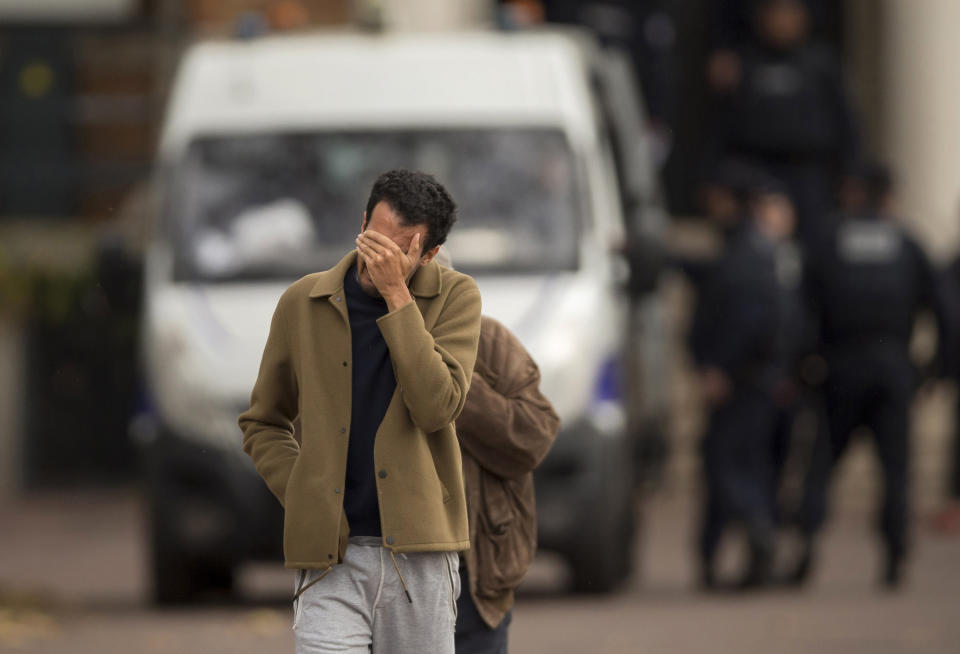 <p>A man hides his face as he leaves the morgue in Paris, Nov. 14, 2015. French President Francois Hollande vowed to attack the Islamic State group without mercy as the jihadist group admitted responsibility for orchestrating the deadliest attacks inflicted on France since World War II. ((Photo: Daniel Ochoa de Olza/AP) </p>