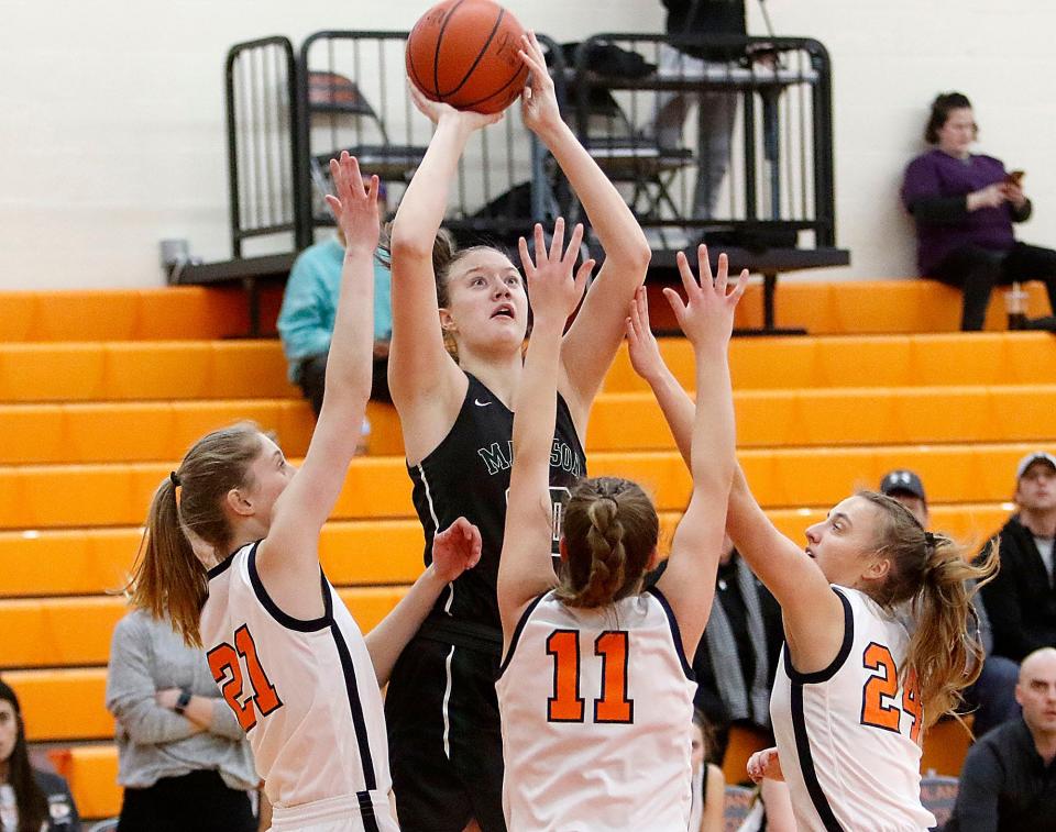 Madison High School's Faith Kuhn shoots as Ashland High School's Lillian Pool (21), Klaira Paramore (11) and Audra McBride (24) defend during high school girls basketball action Thursday, Jan. 20, 2022. TOM E. PUSKAR/TIMES-GAZETTE.COM