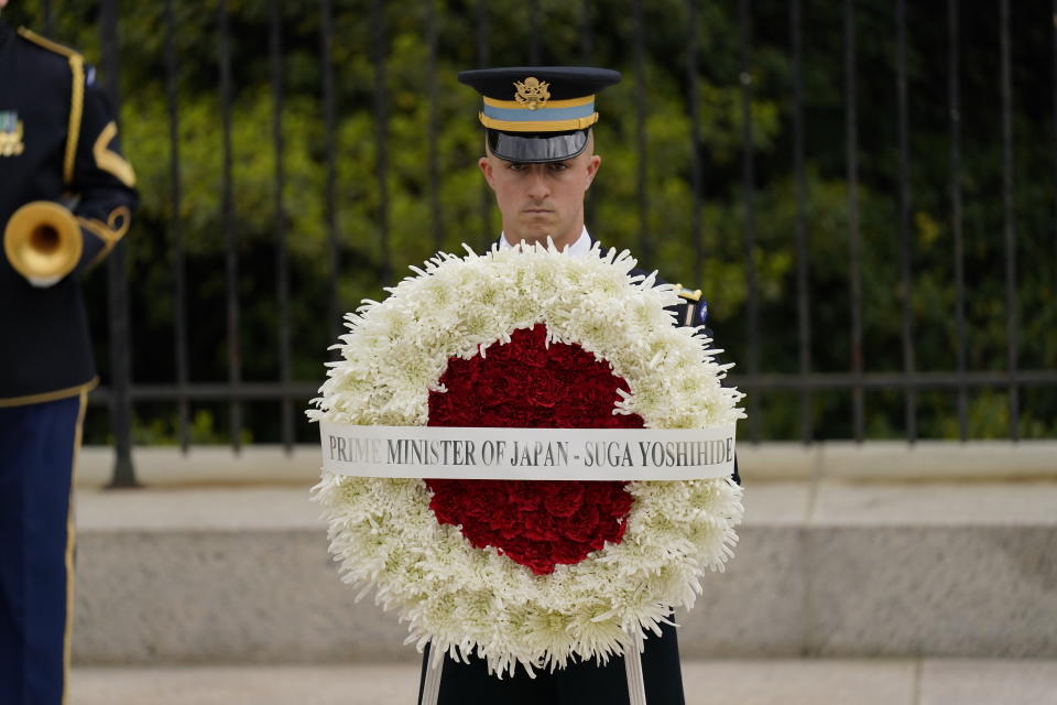 U.S. Honor Guard prepare for Japanese Prime Minister Yoshihide Suga at the Tomb of the Unknown Soldier where he will participate in a wreath laying ceremony at Arlington National Cemetery in Arlington, Va., Friday morning, April 16, 2021. President Joe Biden will be welcoming Japan's prime minister to the White House on Friday in his first face-to-face meeting with a foreign leader, a choice that reflects Biden's emphasis on strengthening alliances to deal with a more assertive China and other global challenges. (AP Photo/Carolyn Kaster)