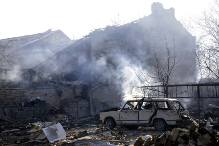 A wrecked car and damaged houses near the site where a train transporting gas derailed and exploded in the northeastern Bulgarian village of Hitrino on December 10, 2016