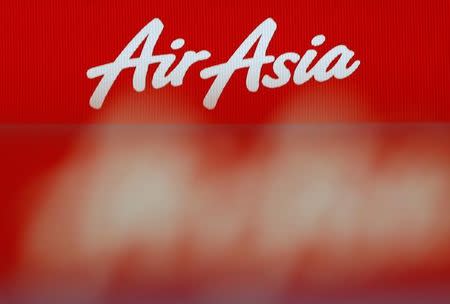 FILE PHOTO: An AirAsia logo is pictured at the ticketing counter at Changi Airport in Singapore December 29, 2014. REUTERS/Edgar Su/File Photo