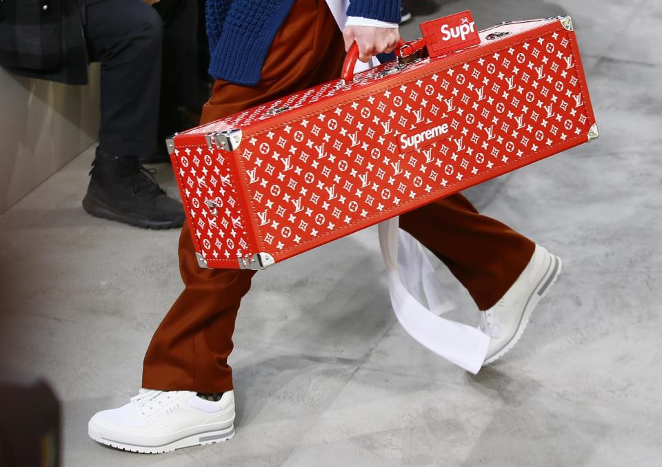 A model carries a case for Louis Vuitton Men's Fall Winter 2017-2018 fashion collection presented in Paris, Thursday, Jan.19, 2017. (AP Photo/Francois Mori)