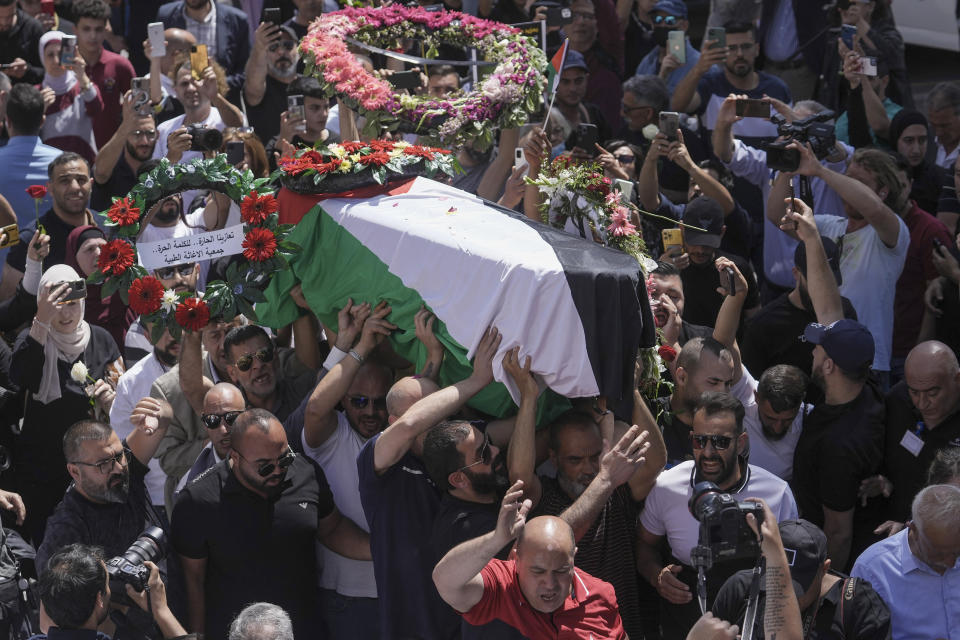 Family, friends and colleagues of slain Al Jazeera journalist Shireen Abu Akleh carry her coffin to a hospital in the east Jerusalem neighborhood of Sheikh Jarrah, Thursday, May 12, 2022. Abu Akleh, a Palestinian-American reporter who covered the Mideast conflict for more than 25 years, was shot dead Wednesday during an Israeli military raid in the West Bank town of Jenin. (AP Photo/Mahmoud Illean)