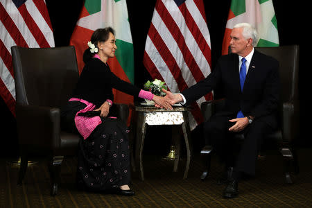 Myanmar's State Counsellor Aung San Suu Kyi shakes hands with U.S. Vice President Mike Pence during their bilateral meeting in Singapore, November 14, 2018. REUTERS/Athit Perawongmetha