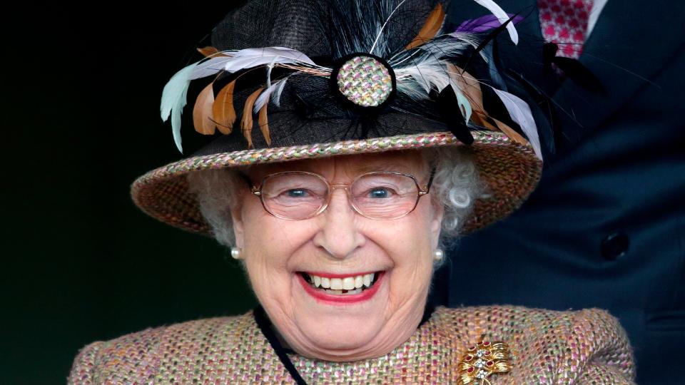 Queen Elizabeth II watches her horse 'Sign Manual' run in and win the Dreweatts Handicap Stakes as she attends the Dubai Duty Free Raceday at Newbury Racecourse on April 19, 2013 in Newbury, England.