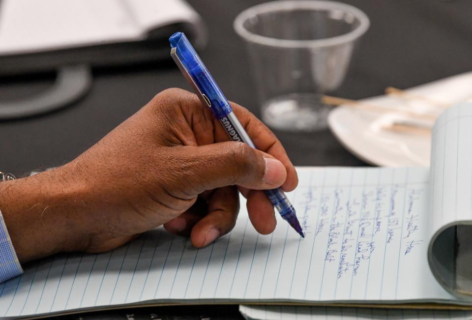 A person takes notes during a session about the Alabama Healthy Homes project Wednesday at Hotel Capstone in Tuscaloosa.