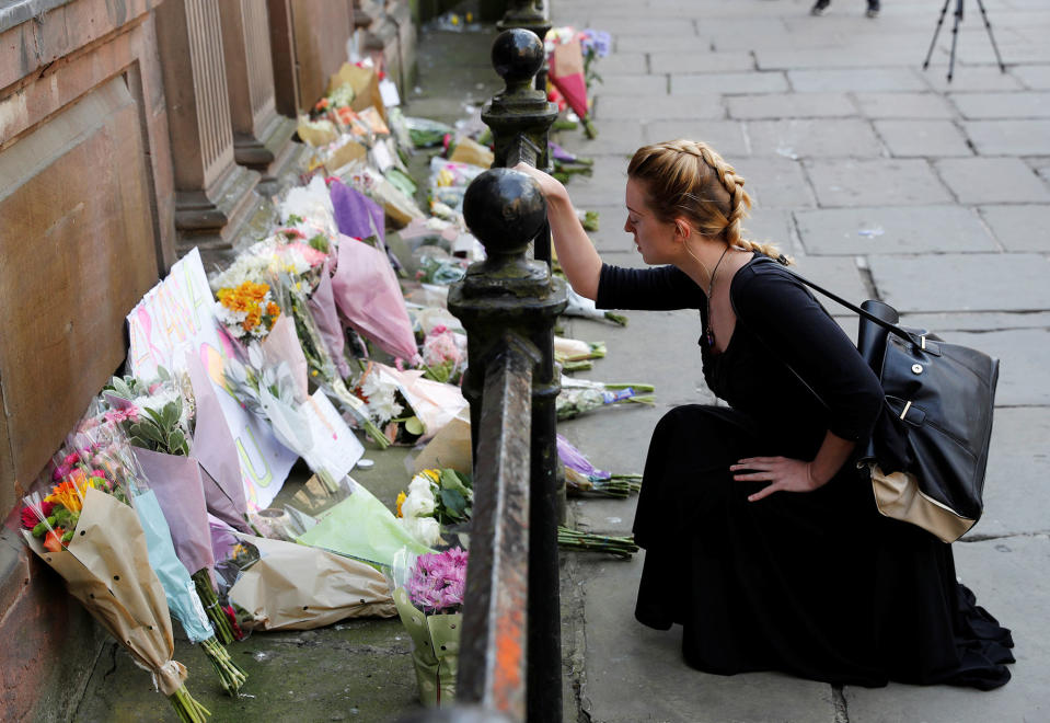 <p>A woman lays flowers for the victims of the Manchester Arena attack, in central Manchester, Britain on May 23, 2017. (Darren Staples/Reuters) </p>