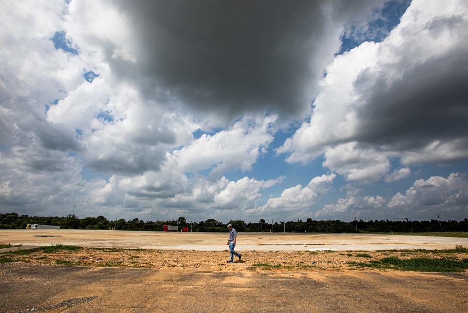 Courier Journal investigative reporter Jonathan Bullington walks the perimeter of the former Mayfield Consumer Products candle factory in Mayfield, Ky.  Nine people were killed when a tornado destroyed the facility on Dec. 10, 2021.