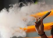 Enthusiast Brandy Tseu uses an electronic cigarette at The Vapor Spot vapor bar in Los Angeles, California March 4, 2014 REUTERS/Mario Anzuoni/File Photo