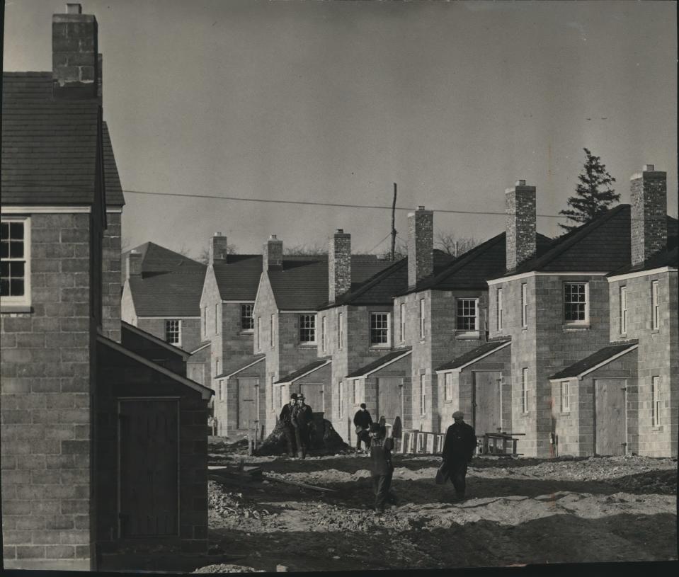 Construction workers are shown crossing what is now a paved street during the building of Greendale in the late 1930s. The community was one of three greenbelt towns built by the federal government.