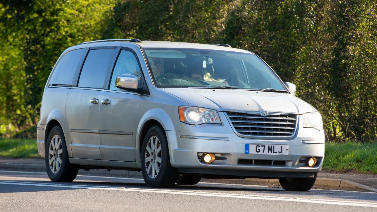 Bicester,Oxon, UK - April 7th 2023. 2011 silver CHRYSLER  GRAND VOYAGER  car travelling on an English country road