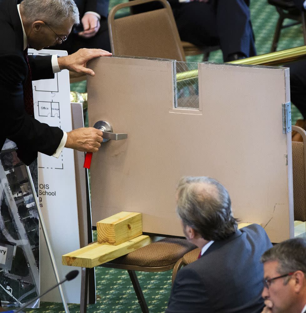 Texas Department of Public Safety Director Steve McCraw shows how an interior door in Robb Elementary School during the hearing at the Texas State Capito on Tuesday.