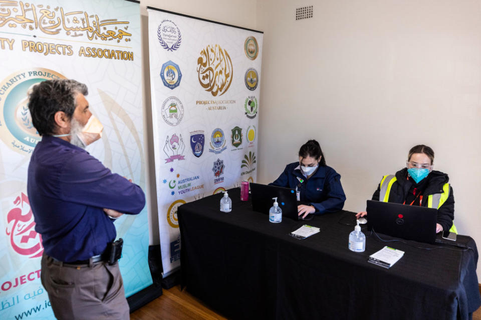 Staff and patients arrive for the first morning of a pop-up, walk-in, AstraZeneca vaccination clinic at Al Amanah College in Lakemba.