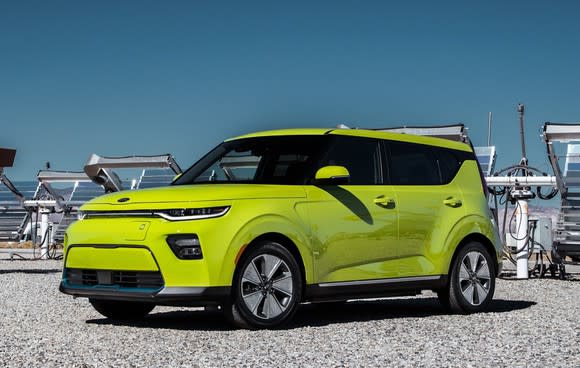 A lime-green 2020 Kia Soul EV, a small electric hatchback.