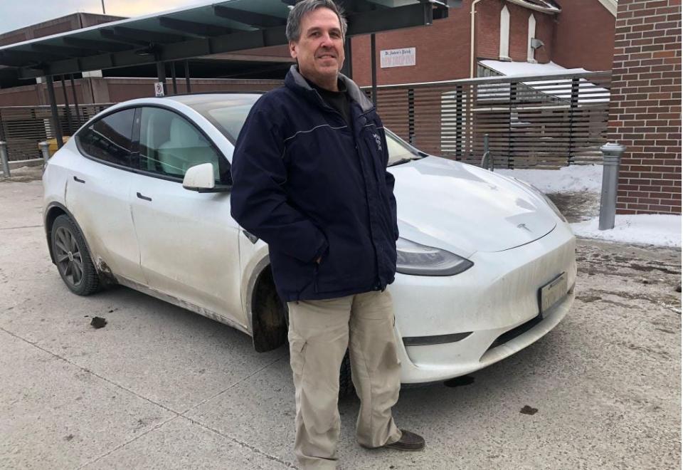 Mike Siska of Thunder Bay stands next to his Tesla.