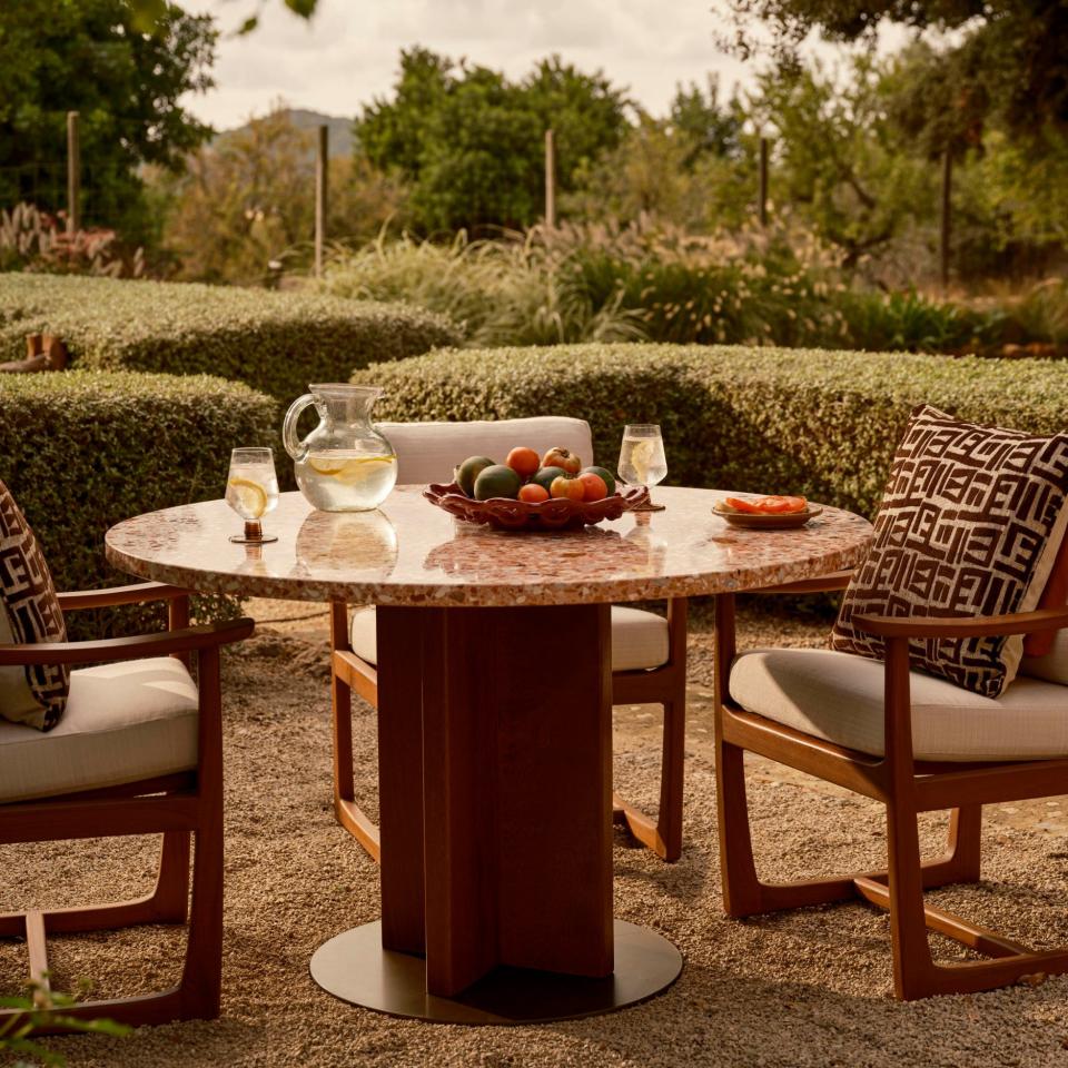 The Dalmati dining table by Soho Home adds a touch of beauty to outdoor spaces