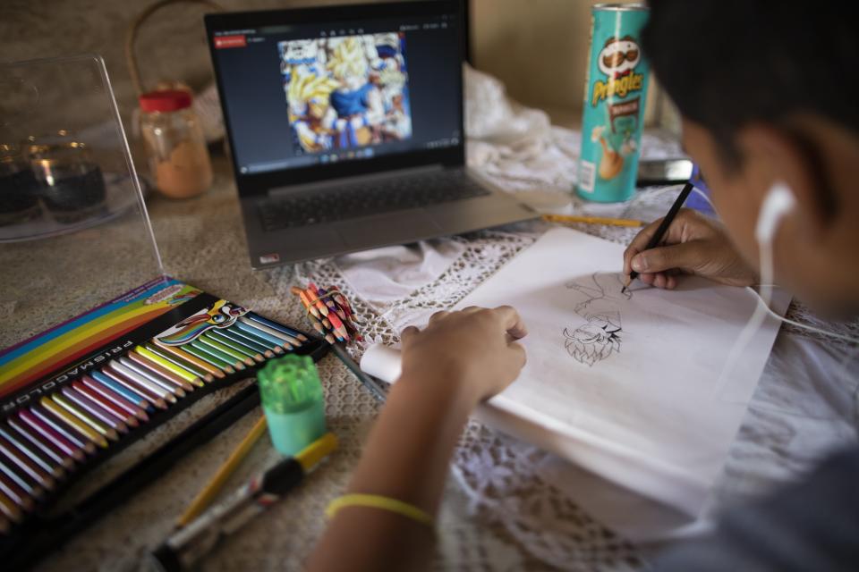 Samuel Andres Mendoza draws at his home, with the intention of selling it online in Barquisimeto, Venezuela, Tuesday, March 2, 2021. In a country where workers earn an average of $2 per month, the teen's drawings can make a big difference for a strained family budget. (AP Photo/Ariana Cubillos)