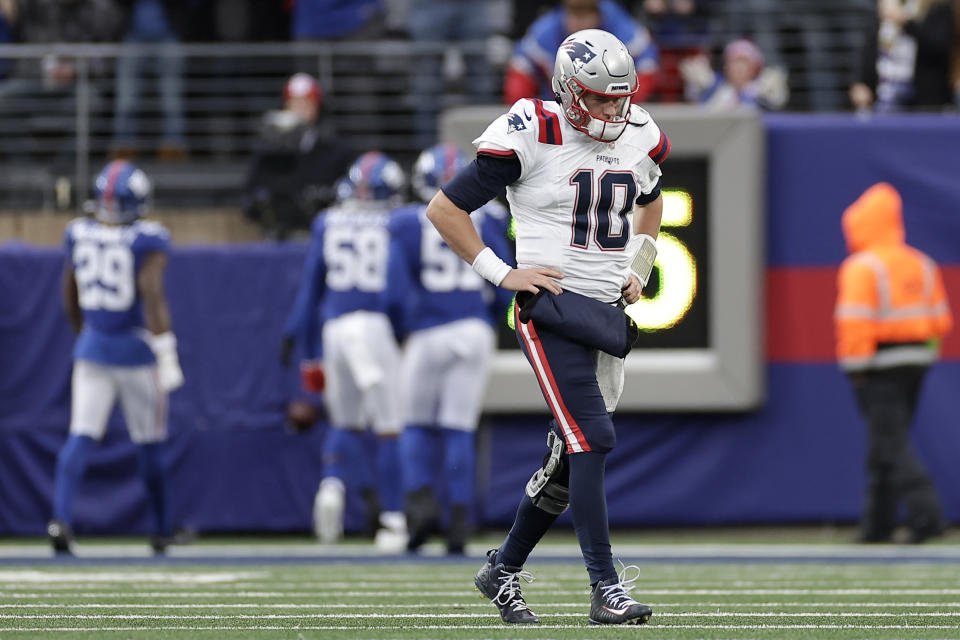 New England Patriots quarterback Mac Jones (10) walks off the field after throwing an interception against the New York Giants during the second quarter of an NFL football game, Sunday, Nov. 26, 2023, in East Rutherford, N.J. (AP Photo/Adam Hunger)