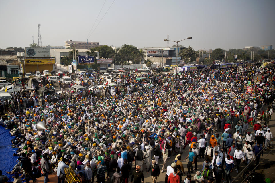 Farmers listen to a speaker as they block a major highway during a protest at the Delhi-Haryana state border, India, Tuesday, Dec. 1, 2020. Talks between protesting farmers and the Indian government failed Tuesday after both the parties could not reach a common ground to discuss the new farming laws, protests against which have intensified after entering their sixth day. More growers joined giant demonstrations and choked roads to India’s Capital by hunkering down along with their trucks and tractors. (AP Photo/Altaf Qadri)