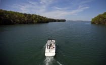 FILE - A boat passes along Lake Lanier, April 23, 2013, in Buford, Ga. Fashion designer Tameka Foster, the ex-wife of R&B singer Usher, is calling to drain Lake Lanier, Georgia's largest lake, where her son was fatally injured 11 years ago. Kile Glover, her 11-year-old son with Bounce TV chairman Ryan Glover, died in July 2012 after a personal watercraft struck the boy as he floated in an inner tube on the lake. (AP Photo/David Goldman, File)