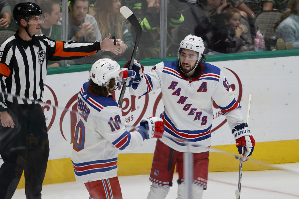 New York Rangers center Mika Zibanejad (93) celebrates his goal against the Dallas Stars with left wing Artemi Panarin (10) during the second period of an NHL hockey game in Dallas, Saturday, Oct. 29, 2022. (AP Photo/Michael Ainsworth)