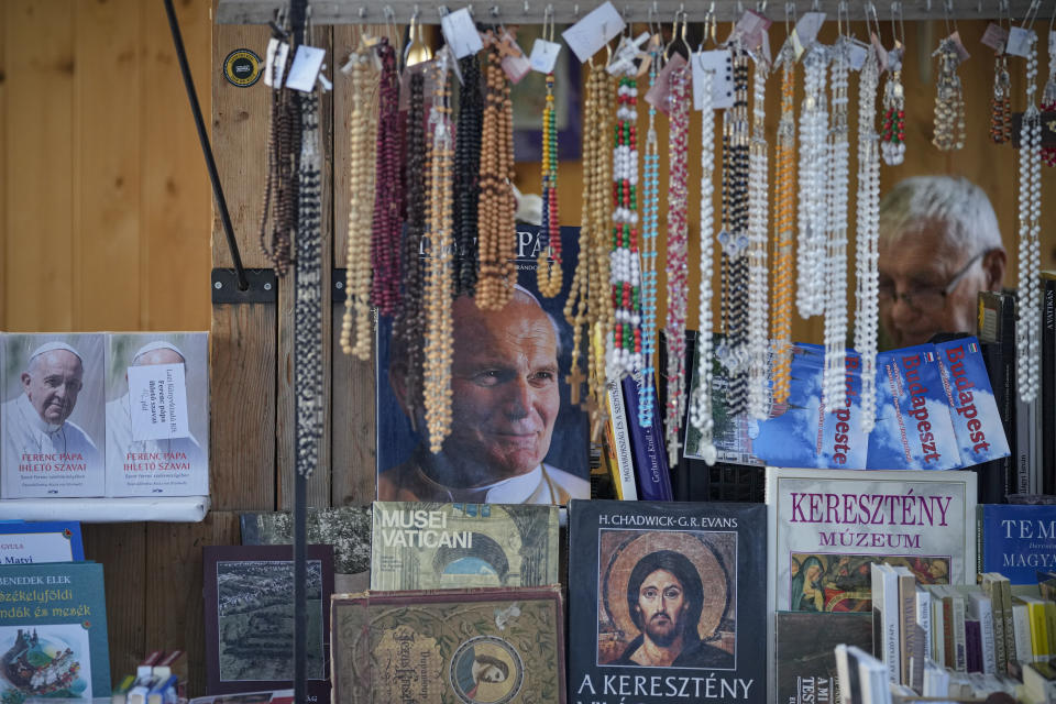 Books covers show Pope Francis and Pope John Paul II at a fair the St. Stephen's Basilica in Budapest, Hungary, Friday, Sept. 10, 2021. Pope Francis is making his first foreign trip since undergoing intestinal surgery in July. His four-day visit to Hungary and Slovakia starting Sunday will not only test his health but also provide what may be one of the most awkward moments of his papacy — a meeting with Hungarian Prime Minister Viktor Orban, the sort of populist, right-wing leader Francis scorns. (AP Photo/Vadim Ghirda)