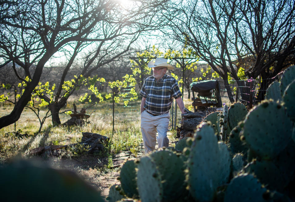 Dan Kelly, a 74-year-old retiree with chronic obstructive pulmonary disease, stands at his Arivaca home on April 15. Kelly has made close to 150 masks for fellow Arivaca residents since the novel coronavirus pandemic. (Photo: Eli Imadali for HuffPost)