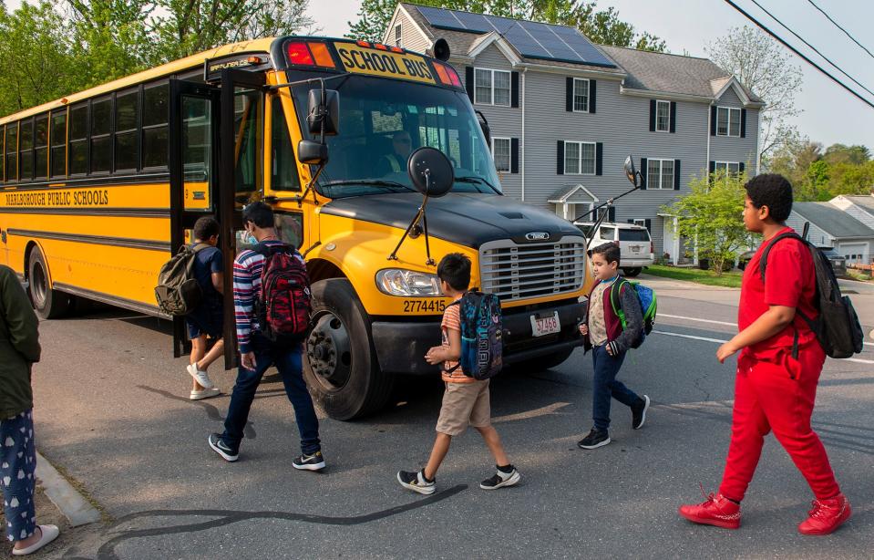 Students who attend the Goodnow Brothers Elementary school in Marlborough board a school bus on Church Street in May.