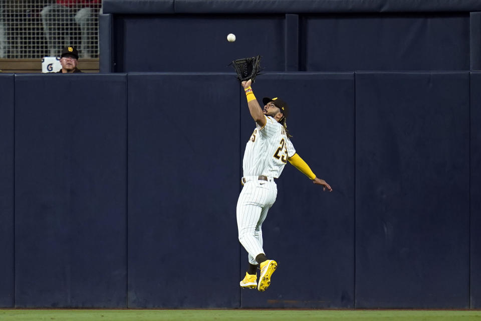 San Diego Padres center fielder Fernando Tatis Jr. makes the catch at the wall for the out on Philadelphia Phillies' Luke Williams during the third inning of a baseball game Friday, Aug. 20, 2021, in San Diego. (AP Photo/Gregory Bull)