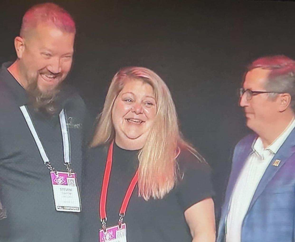 Steve and Melissa Clayton, owners of Three Leg Run Brewery-Winery-Meadery, strike a pose with Bob Pease, Brewers Association President & CEO, after they won a silver award at the World Beer Cup competition in Las Vegas, Nevada on April 24, 2024.