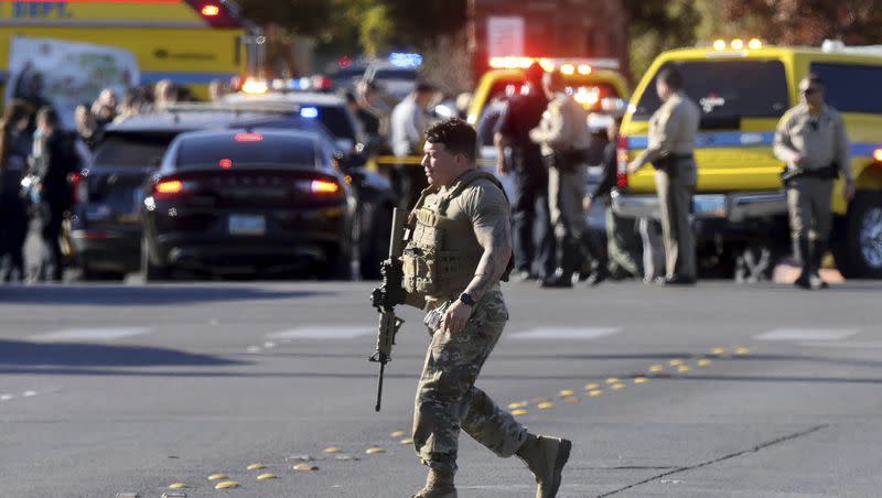 A police officer works the scene of a shooting on the University of Nevada, Las Vegas, campus in Las Vegas, Wednesday, Dec. 6, 2023. 